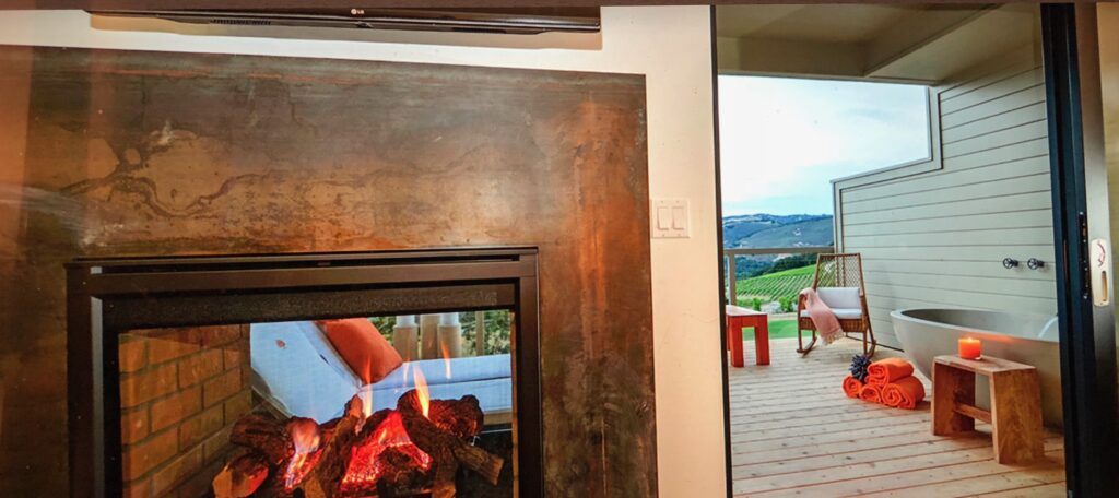 A fireplace with a view of the mountains.