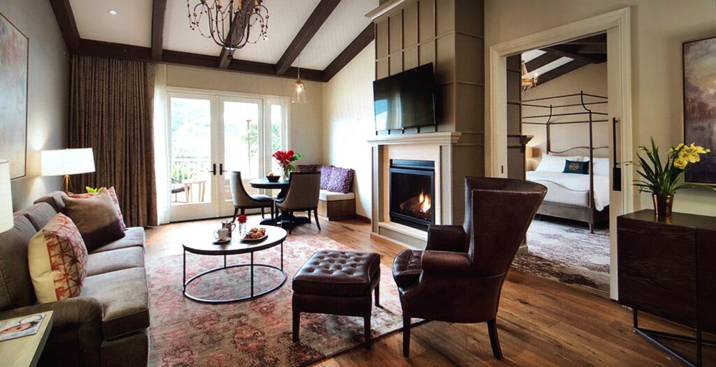 A living room with a fireplace and chairs