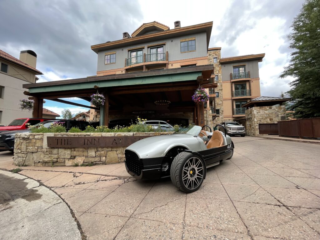 A car parked in front of a hotel.