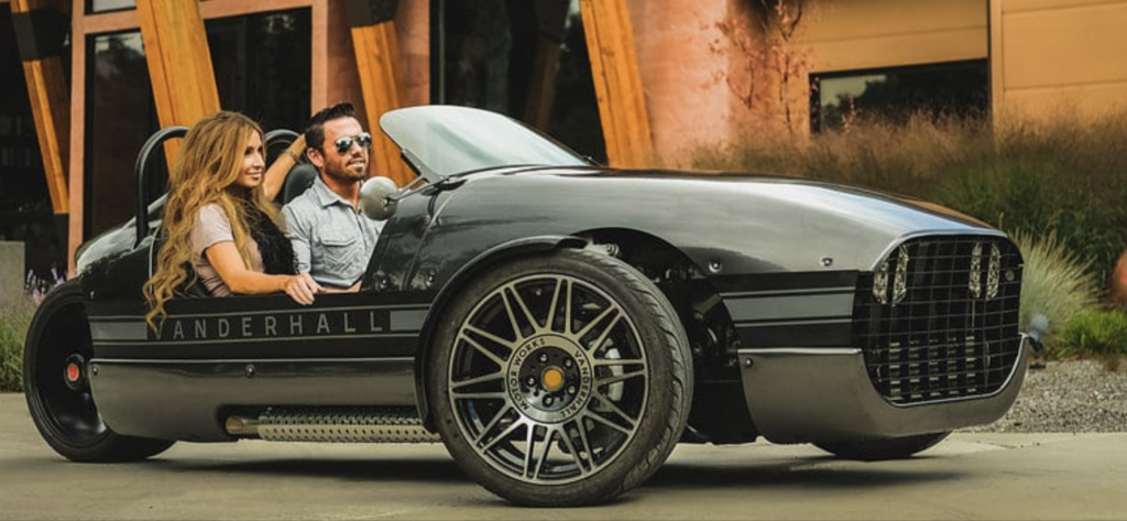 A man sitting in the driver 's seat of a car.