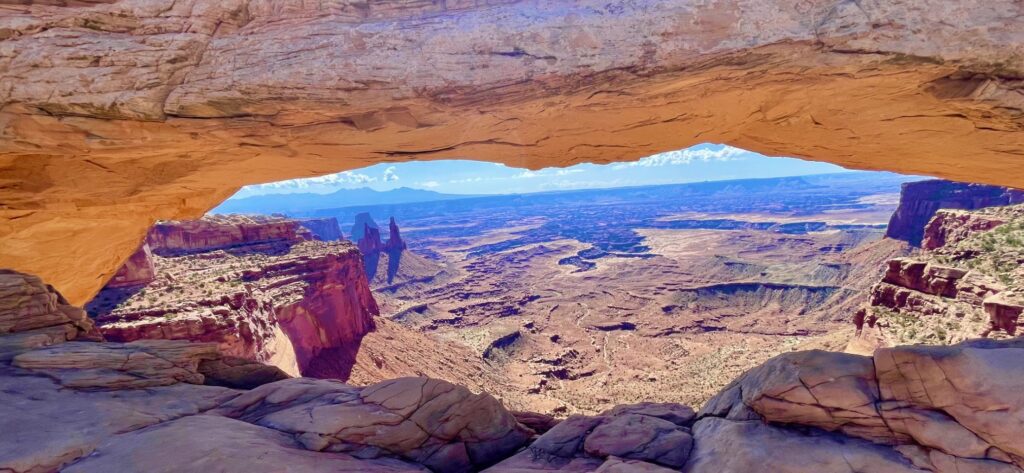 A view of the desert from inside a rock cave.