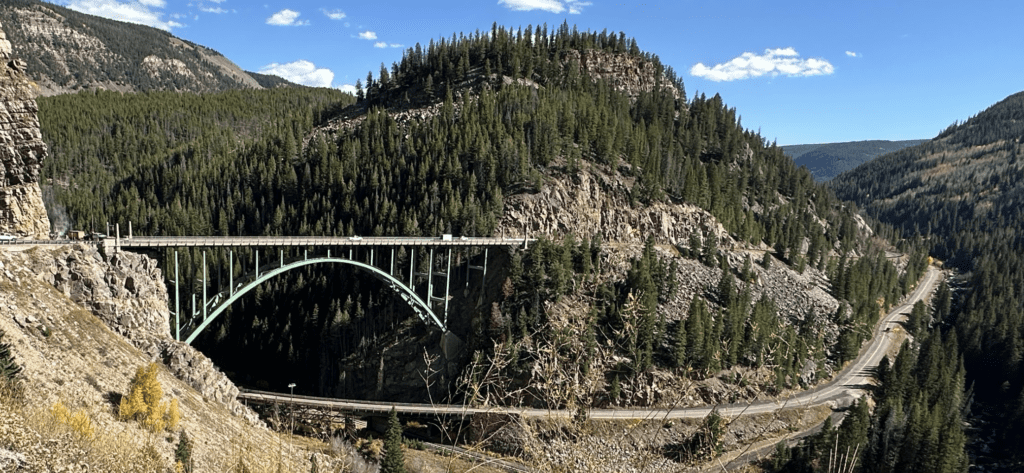 A bridge over the river is on top of a mountain.